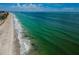 Stunning aerial view of the shoreline with crystal clear turquoise water and white sand beaches at 1600 Gulf Blvd # 514, Clearwater Beach, FL 33767