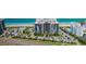Aerial view of beachfront condo building with lush landscaping and parking at 1600 Gulf Blvd # 514, Clearwater Beach, FL 33767