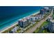 Stunning aerial view of beachfront condos along the coast with turquoise waters and sandy beaches at 1600 Gulf Blvd # 514, Clearwater Beach, FL 33767