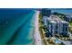 Scenic aerial view of beachfront condos along a beautiful coastline with white sand and clear waters at 1600 Gulf Blvd # 514, Clearwater Beach, FL 33767