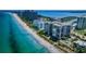 Picturesque aerial view of luxury beachfront condos, a pool, and a pristine coastline at 1600 Gulf Blvd # 514, Clearwater Beach, FL 33767