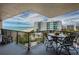 Spacious balcony with a dining table overlooking the beach, ocean, and nearby buildings at 1600 Gulf Blvd # 514, Clearwater Beach, FL 33767