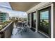 Inviting balcony with a dining set and sliding glass doors overlooking the city and the ocean at 1600 Gulf Blvd # 514, Clearwater Beach, FL 33767