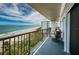 Balcony with seating overlooking a beach and ocean view on a sunny day at 1600 Gulf Blvd # 514, Clearwater Beach, FL 33767