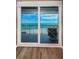 Balcony view showcasing a sliding glass door, beach and ocean views, and a comfortable outdoor chair at 1600 Gulf Blvd # 514, Clearwater Beach, FL 33767