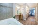 Bathroom featuring a tub, vanity with granite countertop, and tile walls, creating a luxurious space at 1600 Gulf Blvd # 514, Clearwater Beach, FL 33767