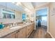 Bathroom with dual sinks, granite countertops, a large mirror, and open access to the bedroom at 1600 Gulf Blvd # 514, Clearwater Beach, FL 33767