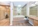Bathroom featuring a tub with jacuzzi, a glass-enclosed shower, and a vanity with granite countertop at 1600 Gulf Blvd # 514, Clearwater Beach, FL 33767