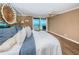 Cozy bedroom with ocean view balcony, wood floors, and coastal-themed decor, creating a relaxing atmosphere at 1600 Gulf Blvd # 514, Clearwater Beach, FL 33767