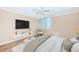 Comfortable bedroom with large window, ceiling fan, wall-mounted tv and neutral decor at 1600 Gulf Blvd # 514, Clearwater Beach, FL 33767