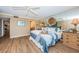 Bedroom featuring wood floors, a dresser, and a full-length mirror, creating a bright and open space at 1600 Gulf Blvd # 514, Clearwater Beach, FL 33767