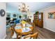 Comfortable dining room featuring a wooden table with sunflower center piece and view of the living room at 1600 Gulf Blvd # 514, Clearwater Beach, FL 33767