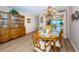 Inviting dining room with wood floors, china cabinet and seating for six beneath an elegant chandelier at 1600 Gulf Blvd # 514, Clearwater Beach, FL 33767