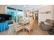 Dining area features a round table, a lounge chair, and views to the balcony, kitchen, and ocean at 1600 Gulf Blvd # 514, Clearwater Beach, FL 33767