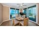 Dining area with a round wooden table and chairs with beach views through sliding glass doors to a balcony at 1600 Gulf Blvd # 514, Clearwater Beach, FL 33767