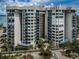 Modern condo building with large balconies, lush landscaping, and a pathway leading to the entrance at 1600 Gulf Blvd # 514, Clearwater Beach, FL 33767