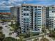 Elegant condo building near beach featuring balconies and lush landscaping, with ample parking space at 1600 Gulf Blvd # 514, Clearwater Beach, FL 33767