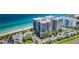 Modern beachfront condo building with a pool and lush landscaping overlooking the ocean at 1600 Gulf Blvd # 514, Clearwater Beach, FL 33767