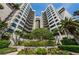 Striking condo building with lush landscaping and mature trees at 1600 Gulf Blvd # 514, Clearwater Beach, FL 33767