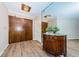Home foyer with mirrored wall, hardwood floors, and wooden double doors at 1600 Gulf Blvd # 514, Clearwater Beach, FL 33767