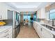 Well-equipped kitchen featuring stainless steel appliances, granite countertops, and views of the water at 1600 Gulf Blvd # 514, Clearwater Beach, FL 33767