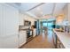 Efficient kitchen with stainless steel appliances, white cabinetry, and view to dining area with water views at 1600 Gulf Blvd # 514, Clearwater Beach, FL 33767