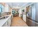 Modern kitchen equipped with stainless steel appliances, light cabinets, and views into the dining area at 1600 Gulf Blvd # 514, Clearwater Beach, FL 33767