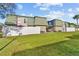 Low-rise condo buildings with green roofs, fenced yard, and well-maintained landscaping at 1799 N Highland Ave # 180, Clearwater, FL 33755