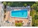 Aerial view of a rectangular pool surrounded by lounge chairs and greenery at 1799 N Highland Ave # 180, Clearwater, FL 33755