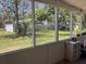 Screened porch provides serene backyard view with lush greenery and privacy fence at 1810 Alcorn Rd, Valrico, FL 33596