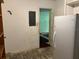 Basement view needs TLC: includes a refrigerator and an electrical panel at 1810 Alcorn Rd, Valrico, FL 33596