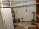 Spacious basement needing repair, includes a refrigerator and water heater at 1810 Alcorn Rd, Valrico, FL 33596