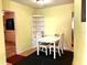 Cozy dining area featuring hardwood floors, a corner shelving unit, and a modern ceiling fan at 1810 Alcorn Rd, Valrico, FL 33596