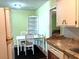 Bright eat-in kitchen with matching table set, plenty of counter space and a classic refrigerator at 1810 Alcorn Rd, Valrico, FL 33596