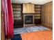 Inviting living room features a brick fireplace, wood paneling, and built-in shelving at 1810 Alcorn Rd, Valrico, FL 33596