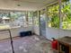 Screened porch with views of the backyard and storage shelves at 1810 Alcorn Rd, Valrico, FL 33596