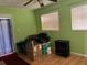 Room interior with windows, wood floors and a vintage heater at 1810 Alcorn Rd, Valrico, FL 33596