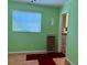 Green room needing repair with a window and a small heater at 1810 Alcorn Rd, Valrico, FL 33596