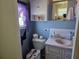 Charming bathroom with blue walls, classic fixtures, and a vanity with ample storage space at 18675 Us Highway 19 N # 318, Clearwater, FL 33764