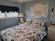 Inviting bedroom featuring nautical bedding, ample lighting, and cozy decor at 18675 Us Highway 19 N # 318, Clearwater, FL 33764
