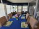 Inviting dining room featuring a table set for six, complemented by neutral walls and flooring at 18675 Us Highway 19 N # 318, Clearwater, FL 33764