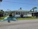 Charming single-story home featuring a spacious carport, well-maintained lawn, and quaint landscaping at 18675 Us Highway 19 N # 318, Clearwater, FL 33764