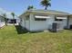 View of the side and back yard of the home, showcasing mature landscaping and awnings at 18675 Us Highway 19 N # 318, Clearwater, FL 33764