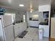 Well-lit kitchen featuring white cabinets, modern appliances, and ample counter space at 18675 Us Highway 19 N # 318, Clearwater, FL 33764