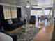 Spacious living room with a comfortable sofa, accent chairs, and an adjacent dining area at 18675 Us Highway 19 N # 318, Clearwater, FL 33764