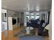 Comfortable living room with stylish furnishings, including a plush sofa, glass table, and ceiling fan at 18675 Us Highway 19 N # 318, Clearwater, FL 33764