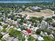 Aerial view of the property showcases a residential neighborhood surrounded by lush greenery at 2113 Malcolm Dr, Palm Harbor, FL 34684