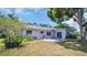 Backyard with patio, manicured landscaping and beautiful green space at 2113 Malcolm Dr, Palm Harbor, FL 34684