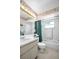 Bathroom with vanity and bathtub-shower combination featuring flower-themed wallpaper and decor at 2113 Malcolm Dr, Palm Harbor, FL 34684