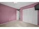 Bedroom with mauve colored walls and large closet at 2113 Malcolm Dr, Palm Harbor, FL 34684